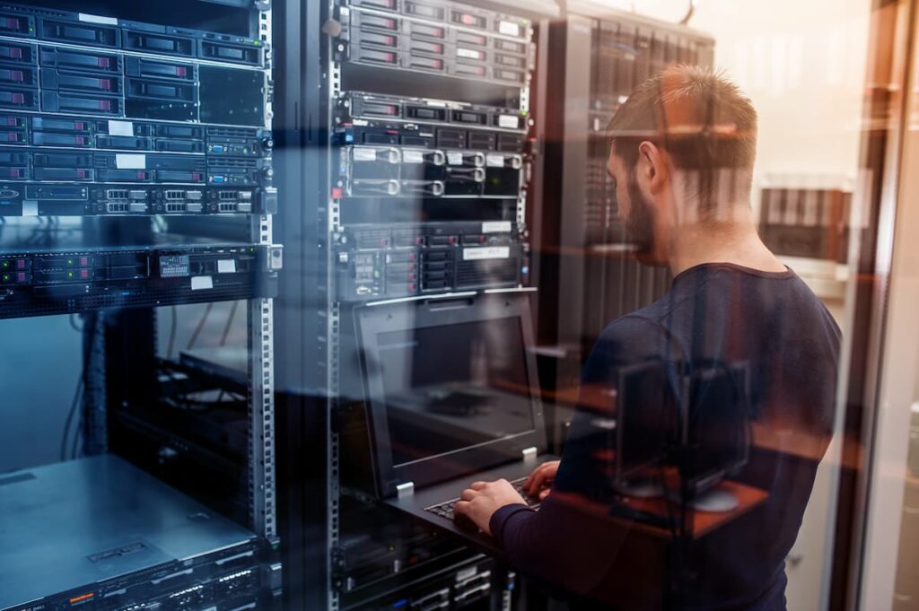 A picture of a network engineer working on network equipment in a data center.